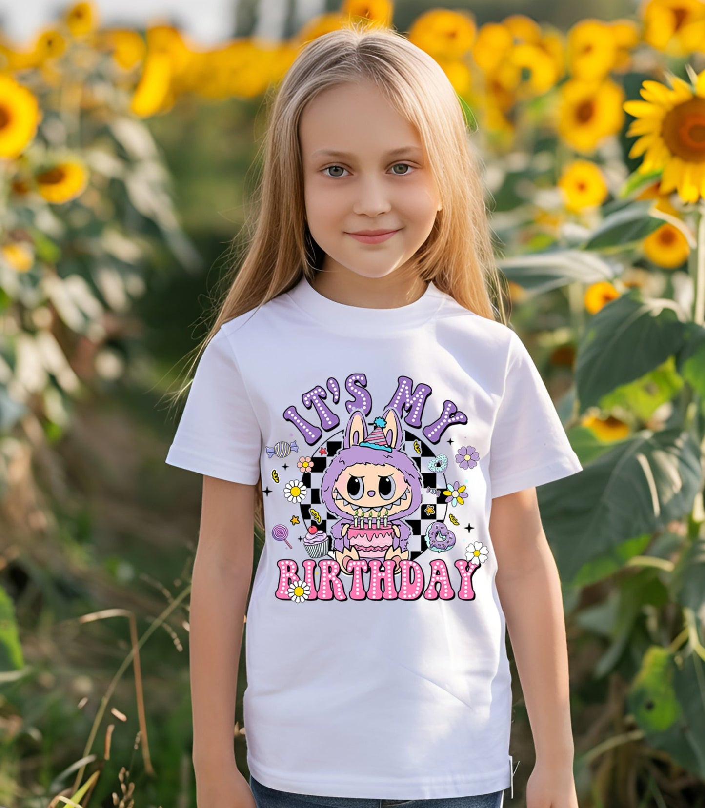 Young girl wearing a 'It's My Birthday' t-shirt in a sunflower field