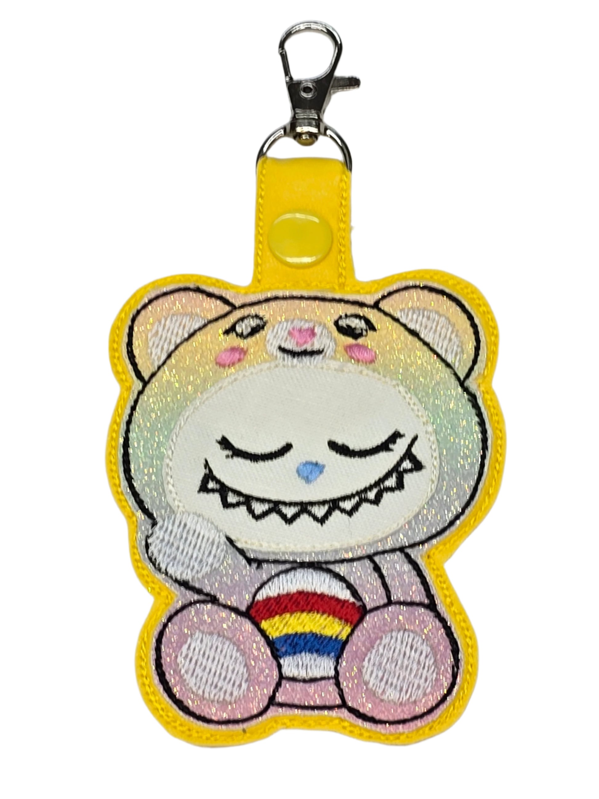 Colorful cartoon character keychain with rainbow on a white background